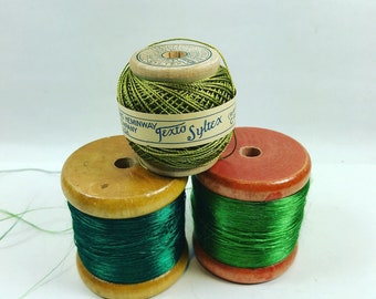 Vintage wooden spools of green thread