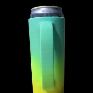 May include: A teal, green, and yellow gradient can cooler with a handle, holding a silver can. The cooler is designed to keep beverages cold and features a smooth, solid texture. The handle is integrated into the cooler's design.
