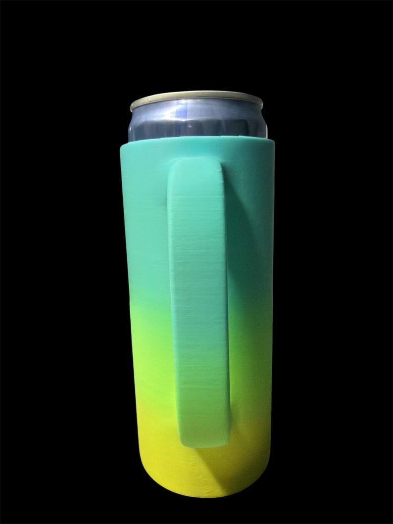 May include: A teal, green, and yellow gradient can cooler with a handle, holding a silver can. The cooler is designed to keep beverages cold and features a smooth, solid texture. The handle is integrated into the cooler's design.