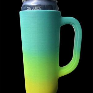May include: A tall, gradient-colored can cooler with a handle, holding a can labeled "3% JUICE." The cooler transitions from yellow to green to teal. The handle is a curved, open design.