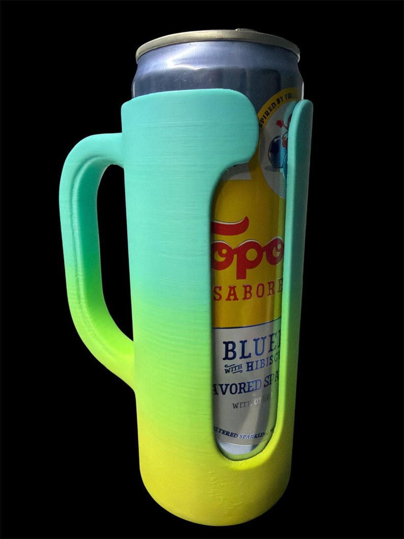 May include: A gradient green and yellow can cooler with a handle, holding a can of Topo Chico sparkling water. The cooler is designed to fit a standard-sized can and features a handle for easy carrying.