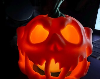 May include: A glowing orange Halloween pumpkin with carved eyes and a mouth. The pumpkin has a green stem and is lit from within, creating a warm, inviting glow. The pumpkin is a festive decoration for the fall season.
