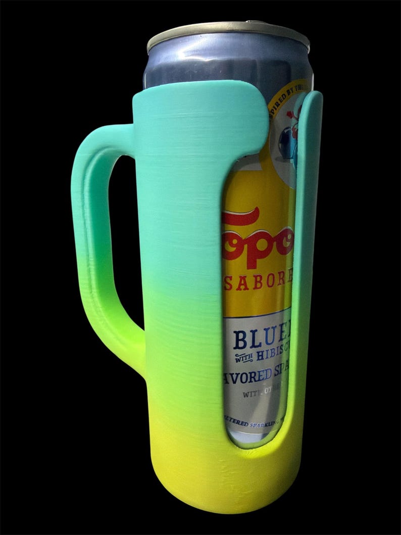 May include: A gradient-colored can cooler in shades of green and yellow, designed to hold a standard beverage can. The cooler has a handle for easy carrying and a snug fit to keep drinks cold. The can inside is yellow and blue.