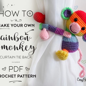 May include: A crochet pattern for a rainbow monkey curtain tie back. The pattern is available as a PDF download. The image shows a finished rainbow monkey curtain tie back.