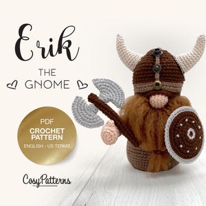 May include: Crochet pattern for a gnome named Erik, wearing a brown and white Viking helmet, holding an axe and a shield. The pattern is in PDF format and written in English using US terms.