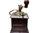 Antique Deep Ebony Wooden Kitchen Table Top Grinder Featuring an Ornately Scrolled Cast Iron Removable Lid and Wooden Spinning Crank Handle