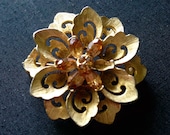 Vintage Designer Gardenia Style Gold Tone Floral Brooch Featuring Amber Colored Rhinestone Accents