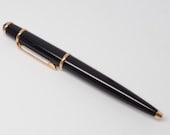 Authentic Cartier Retractable Diabolo Ballpoint Pen With Signature Cobalt Cabochon Crown Featuring Sleek Black And Gold Accented Design