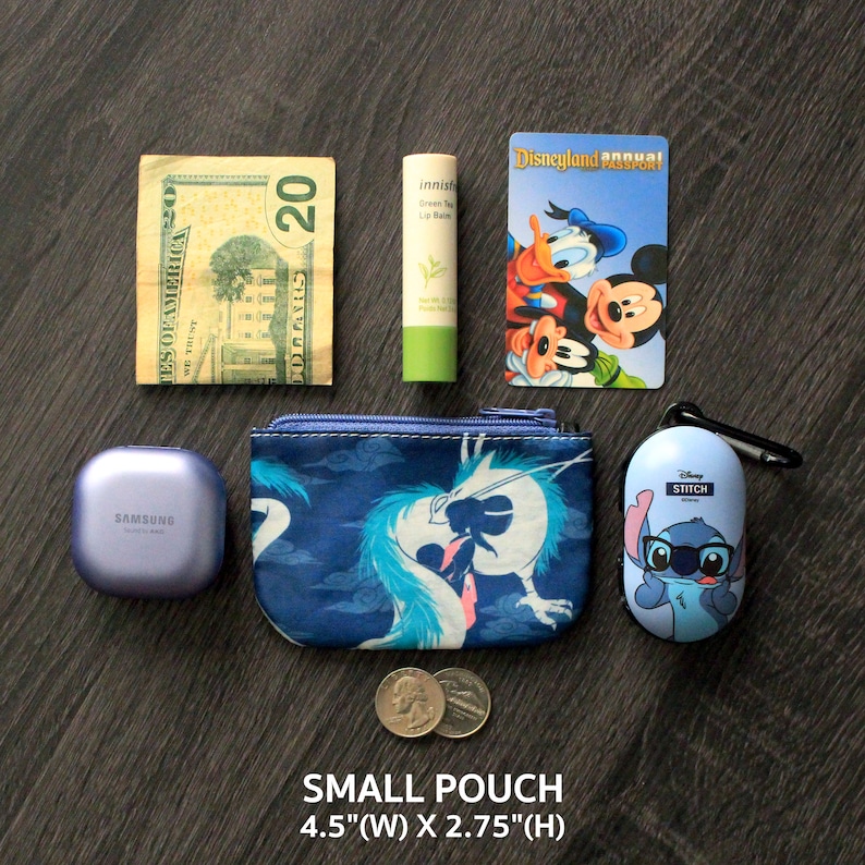 May include: A collection of everyday items: a &pound;20 note, green lip balm, a Disneyland annual pass, a Samsung Galaxy Buds case, a small blue pouch with a dragon design, two coins, and a Stitch-themed earbud case. The small pouch measures 11.4 cm wide and 7 cm high.