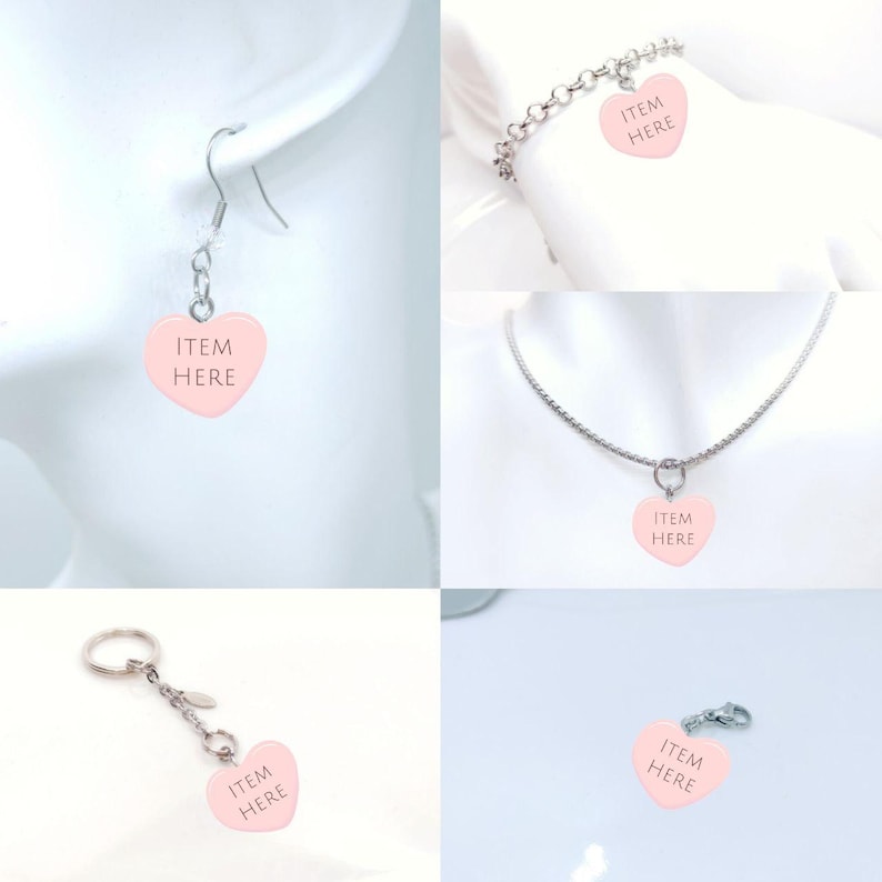 May include: A collection of jewelry items featuring pink heart-shaped charms with the text "ITEM HERE". The items include earrings, a bracelet, a necklace, a keychain, and a charm. The charms are attached to silver-colored metal chains and findings.