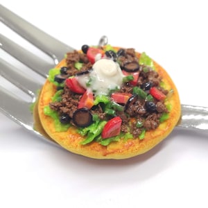 May include: A white ceramic mug with a black handle and the text "But First, Coffee" in a black, bold font. The mug is on a white surface.