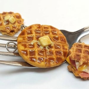 May include: A set of three ceramic mugs with a speckled, matte finish. The mugs are in shades of cream, light gray, and dark gray. Each mug has a simple, minimalist design, perfect for coffee or tea.