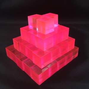 May include: A white ceramic mug with a black handle and the text "But First, Coffee" in a black, handwritten-style font. The mug is on a white surface.