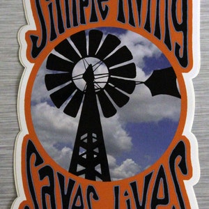 May include: A sticker with the text "Simple Living Saves Lives" in black, outlined in orange, and set against a white background. The center features a windmill silhouette against a blue sky with clouds.