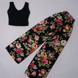 May include: A black tank top and floral print pants. The pants have a black background with pink, yellow, and green flowers.