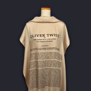 May include: A beige scarf with the text "Oliver Twist" and the first chapter of the book printed on it.