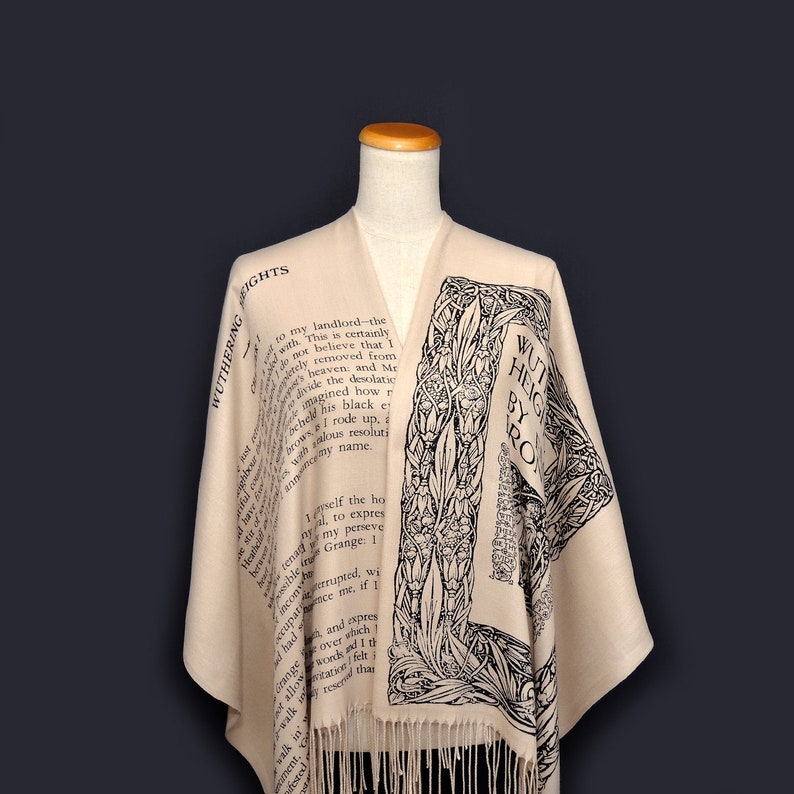 May include: A beige shawl with black text and floral designs. The text reads "Wuthering Heights by Emily Bronte".