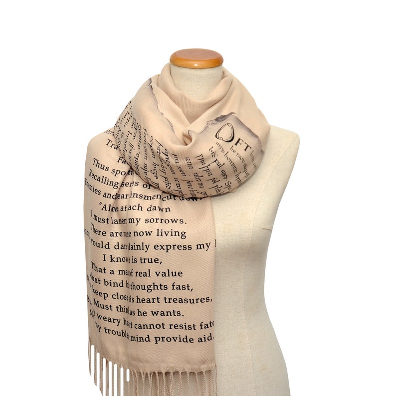 May include: A beige scarf with black text printed on it. The text is a poem that reads: "Thus spoke... provide aid."