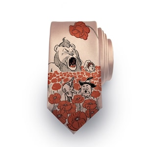 May include: A pink silk tie with a print of the Cowardly Lion, the Tin Man, and the Scarecrow from The Wizard of Oz standing in a field of red poppies.
