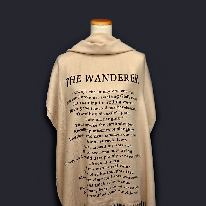May include: A beige shawl with black text that reads "THE WANDERER" and a poem about a lonely wanderer. The poem includes the lines "Always the lonely one endures, His mind anxious, awaiting God's mercy." and "Fate unchanging."