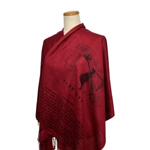 May include: A red scarf with a black print of the text "Jane Eyre" and a silhouette of a woman. The text includes the chapter number and a passage from the book.