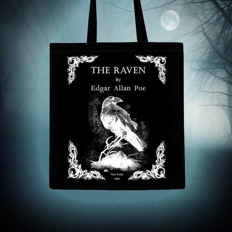 May include: Black tote bag featuring a white illustration of a raven and the text "THE RAVEN" by Edgar Allan Poe. The illustration is surrounded by ornate white flourishes.
