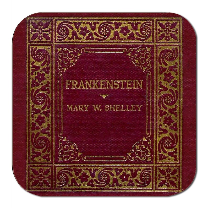 May include: A square, burgundy coaster featuring the title "FRANKENSTEIN" and author "MARY W. SHELLEY" in gold lettering. The coaster has a gold decorative border with floral and scroll designs.