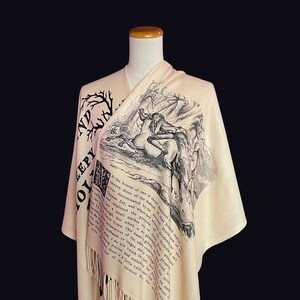 May include: A beige shawl with black text and an illustration of a man riding a horse. The text reads "In the bosom of one of those spacious eastern shore of the Hudson, that river denominated by the ancient Dutch of the Tappan Zee, and when hay sways prudently the wind, a small market is or was kept, and to which the good people of the neighbouring country would resort to dispose of their produce, and to buy town this name given to it, properly belongs to the little adjacent village, for the housewives of the town, as the old inhabitants do not linger about the fair, and indeed, there is no such village, for the simple reason that there is a little valley, in the bosom of which, and further up the river, is the quietest the"