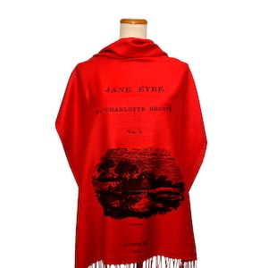 May include: Red scarf with a black print of the book cover for "Jane Eyre" by Charlotte Bronte. The cover features the title, author, volume number, and a black and white illustration.