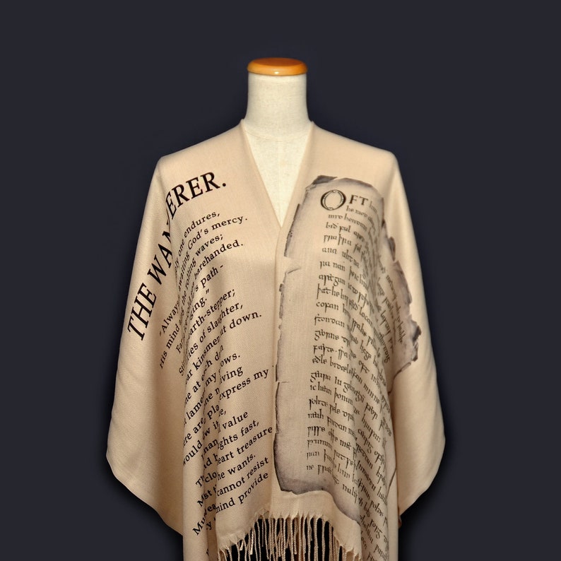 May include: A beige shawl with black text printed on it. The text reads "The Wanderer" and "Oft" with a poem printed on the shawl.