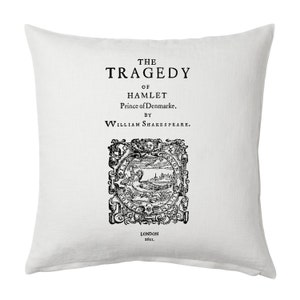 May include: A white pillow with black text that reads "THE TRAGEDY OF HAMLET Prince of Denmarke. BY WILLIAM SHAKESPEARE. LONDON 1611."