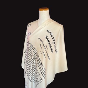 May include: A white scarf with black text that reads "Преступление и наказание" (Crime and Punishment) in Russian. The text is from the title page of the novel by Fyodor Dostoevsky.