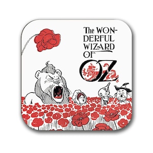 May include: A white coaster with a black and white illustration of the characters from the Wizard of Oz. The text "The Wonderful Wizard of Oz" is printed in black at the top of the coaster. The characters are standing in a field of red poppies.