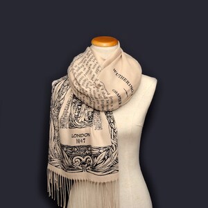 May include: A beige scarf with black text and illustrations. The text includes the title "Wuthering Heights" and the chapter number. The scarf also has the text "London 1847" printed on it.