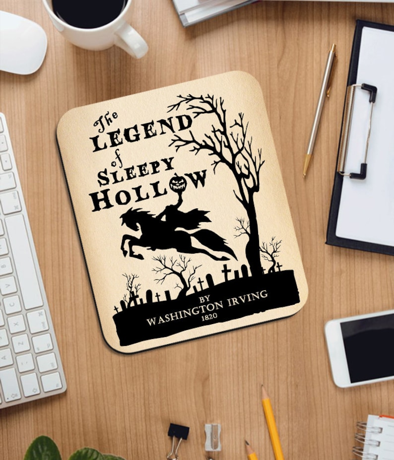 May include: A black and white mousepad with a spooky illustration of the Headless Horseman riding a horse through a graveyard. The text reads "The Legend of Sleepy Hollow by Washington Irving 1820".