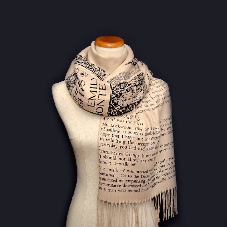 May include: A beige scarf with black text printed on it. The text is from the novel "Wuthering Heights" by Emily Bront&euml;. The scarf is draped over a mannequin.
