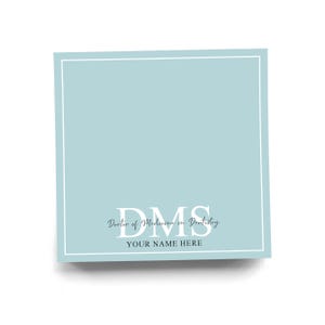 May include: A square, light blue card with a white border. The text "DMS Doctor of Medicine in Dentistry" is centered, with "YOUR NAME HERE" below. The design is simple and elegant.