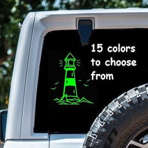 May include: White Jeep Wrangler with a black tire and a sticker on the back window. The sticker features a lighthouse with the text "15 colors to choose from".