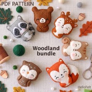 May include: A collection of handmade felt woodland animal ornaments, including a raccoon, bear, deer, squirrel, owl, and fox. The ornaments are in shades of brown, gray, orange, and white, with embroidered details. The text "Woodland bundle" and "PDF Pattern" are visible.