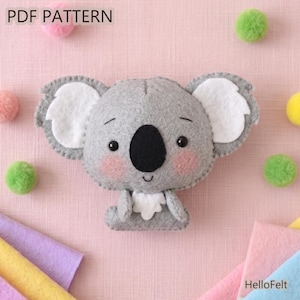 May include: A gray felt koala plush toy with white inner ears, a large black nose, and pink cheeks. The text PDF PATTERN is visible in the top left corner, and the text HelloFelt is visible in the bottom right corner of the image.