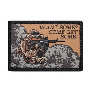 May include: A black and tan embroidered patch with a soldier holding a rifle in a smoky background. The text on the patch reads "WANT SOME? COME GET SOME!"