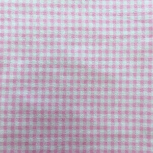 May include: Pink and white gingham fabric with a small checkered pattern.