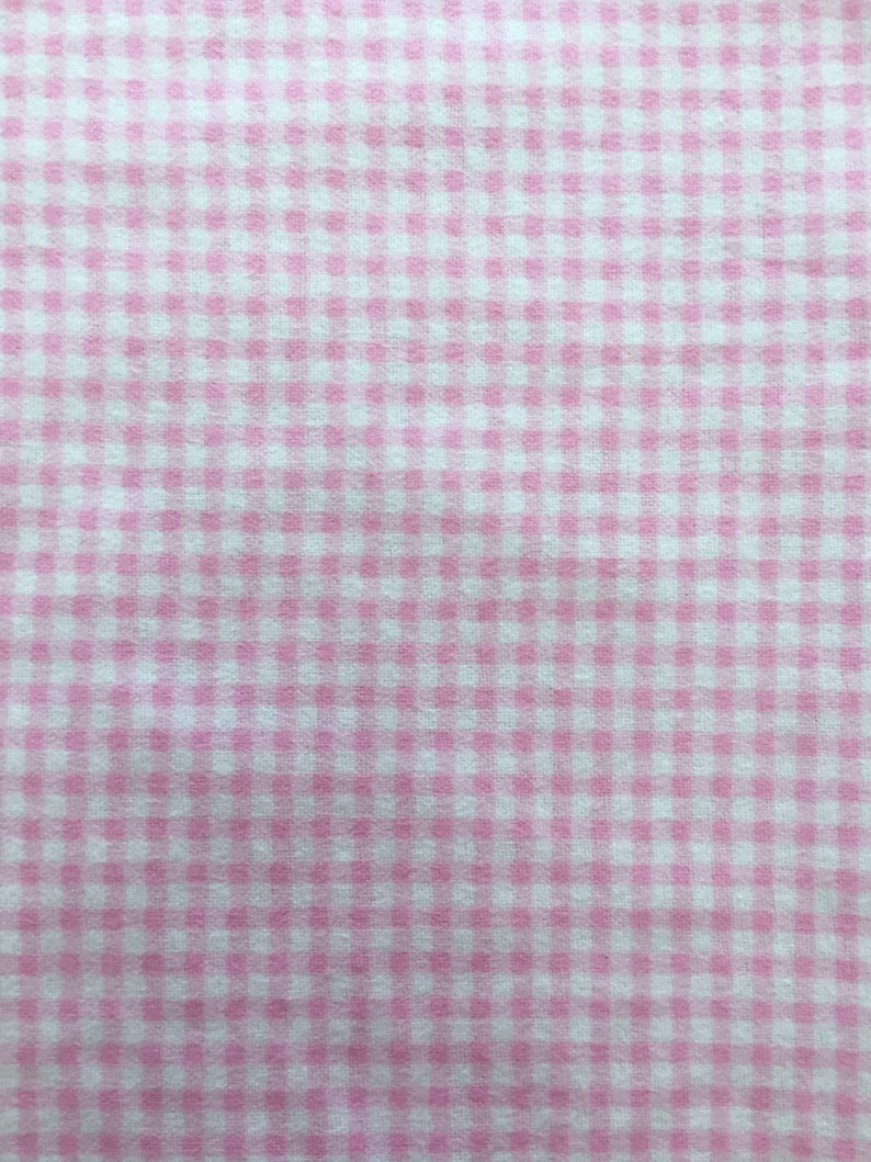 May include: Pink and white gingham fabric with a small checkered pattern.