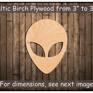 May include: A wooden cutout of an alien head, made from Baltic birch plywood. The cutout is on a woodgrain background. The text "Baltic Birch Plywood from 3" to 35" is at the top of the image. The text "For dimensions, see next image" is at the bottom of the image.