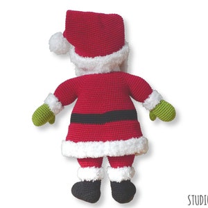 May include: A crocheted Santa Claus doll with a red suit, white trim, black belt, green mittens, and black boots. The doll is facing away from the camera.