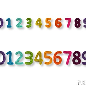 May include: Two rows of crocheted numbers 0 through 9 in a rainbow of colors. The numbers are in purple, blue, teal, green, yellow, orange, red, pink, burgundy, and dark purple. The numbers are on a white background.