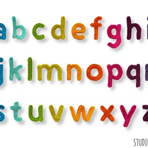 May include: A colorful alphabet made of crocheted letters. The letters are arranged in three rows, with each row featuring a different color scheme. The letters are a, b, c, d, e, f, g, h, i, j, k, l, m, n, o, p, q, r, s, t, u, v, w, x, y, and z.
