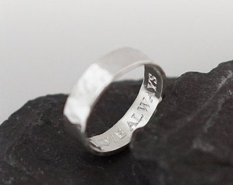 May include: A silver band ring with a hammered texture. The ring is engraved with the words "Forever & Always".