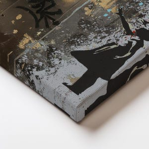 May include: A canvas wall art print featuring a black silhouette of a person with arms raised against a textured background of dark gray, brown, and gold leaf accents. The artwork displays a distressed, urban aesthetic with splattered paint details.