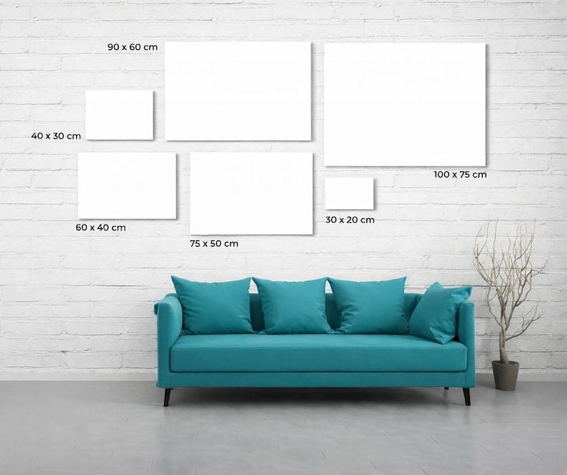May include: A teal sofa with five matching cushions positioned below a gallery wall arrangement of six blank white rectangular canvases. The canvases are labeled with dimensions: 40x30 cm, 90x60 cm, 100x75 cm, 60x40 cm, 75x50 cm, and 30x20 cm.